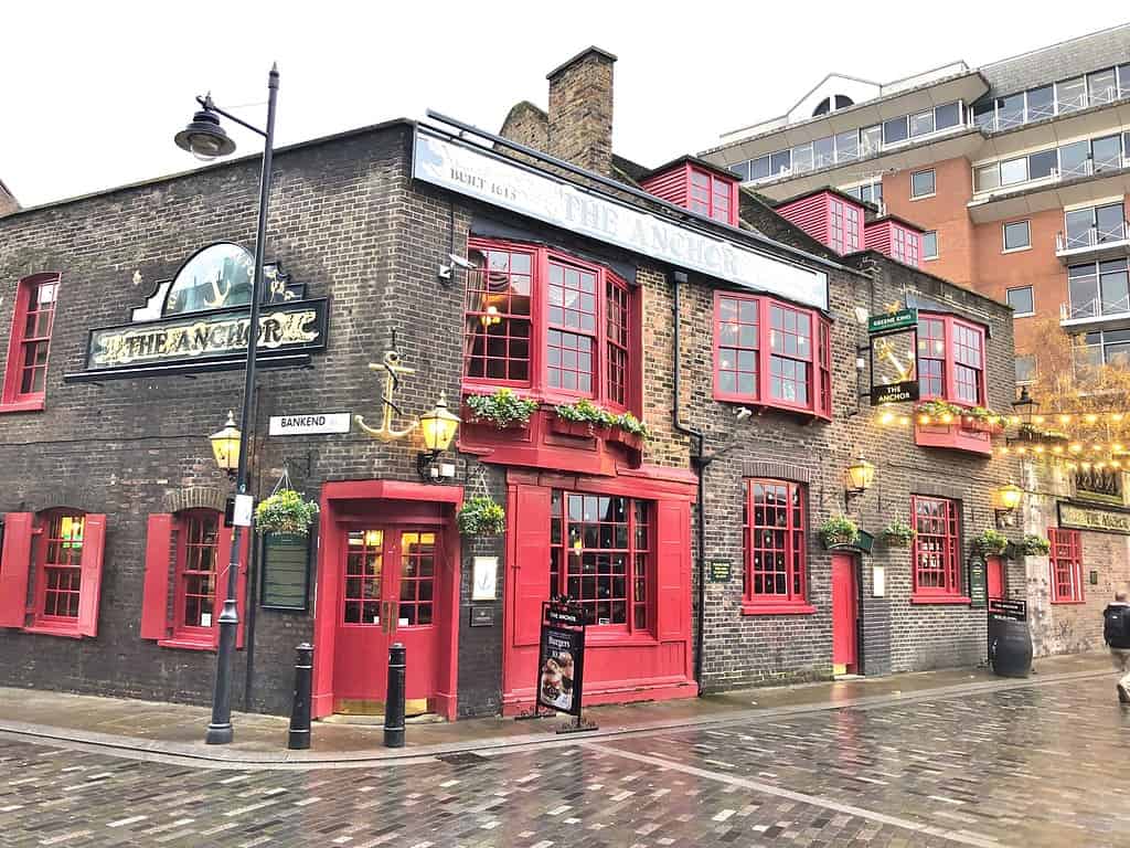 The Anchor on Bankside, Southwark, London, UK. A distinguishable pub with it's brick building and red windows and doors.