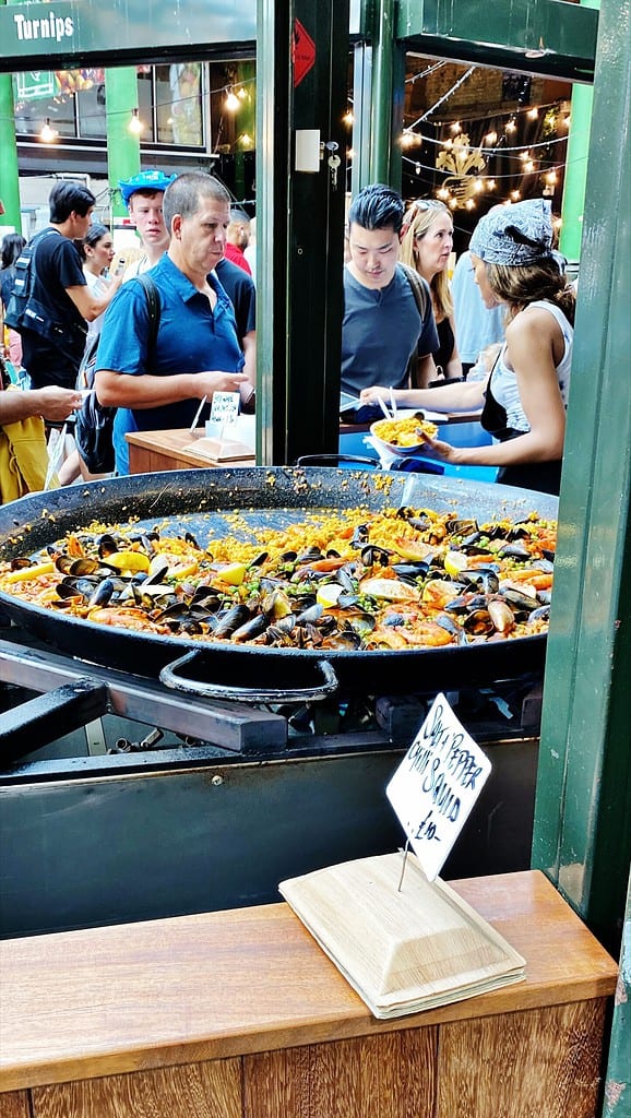 Borough Market. A vendor selling Paella, is on the busiest places at the Market.