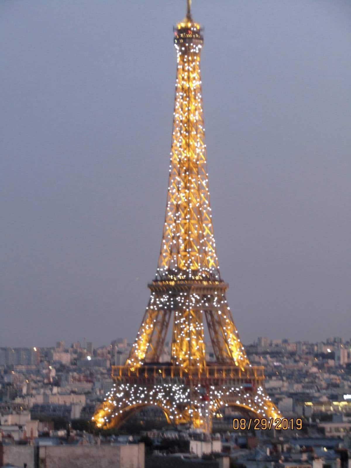 Eiffel Tower lit up at night viewed from Arc d' Triomphe was on our Bucket List in 2019