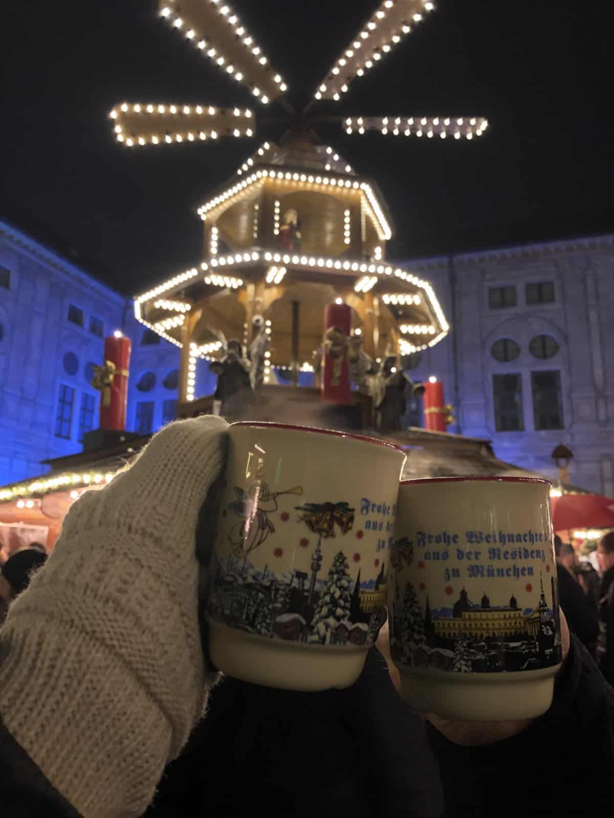 Gluhwein mugs in front of the Christmas Pyramid at the Christmas Market in Munich