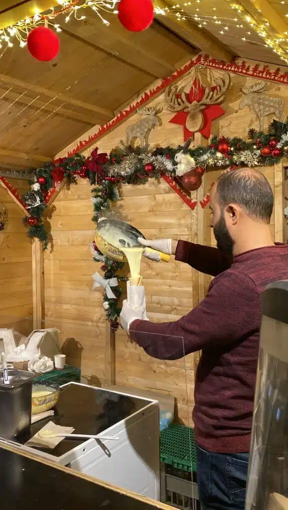 Melted cheese being poured into a baguette. There was so much cheese at the Markets!