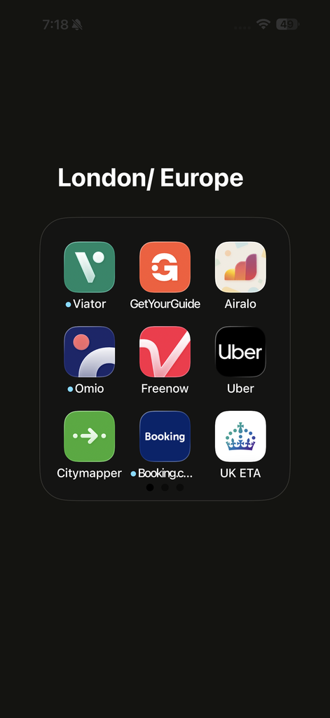 Smartphone home screen folder titled “London/ Europe” containing some of the best travel apps for planning, including Viator, GetYourGuide, Airalo, Omio, Freenow, Uber, Citymapper, Booking.com, and UK ETA.
